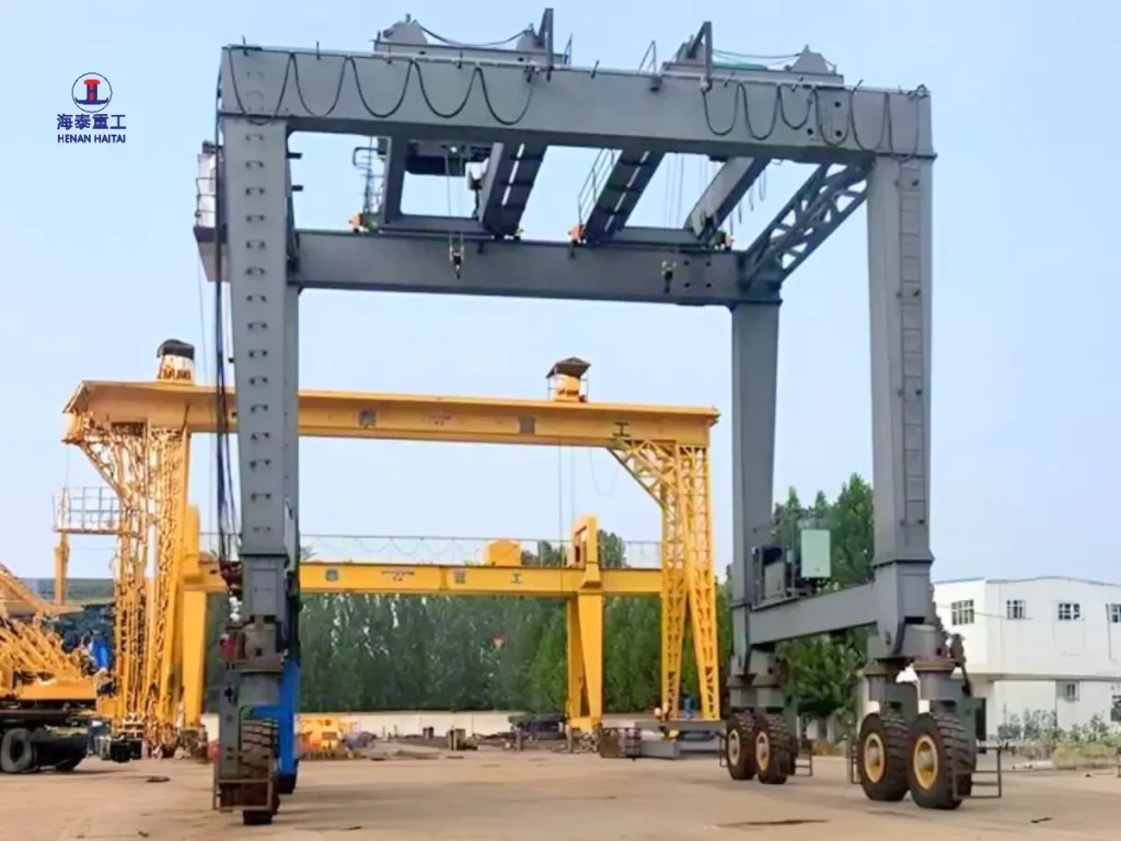 Close view of the crane's gantry legs, hoisting mechanism, and electrical control cabin