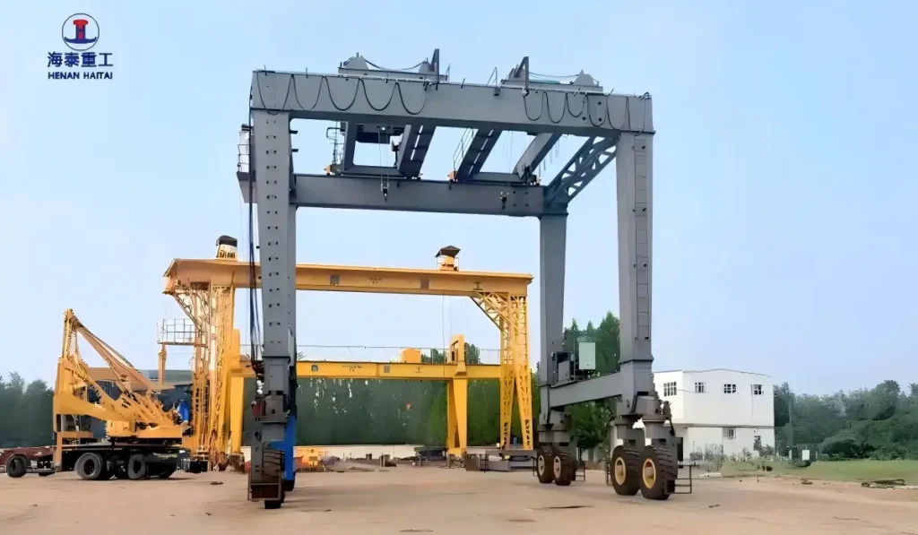 The 60 ton, 12.1m-span RTG crane on site in Saudi Arabia, alongside another Haitai gantry crane and a mobile crane