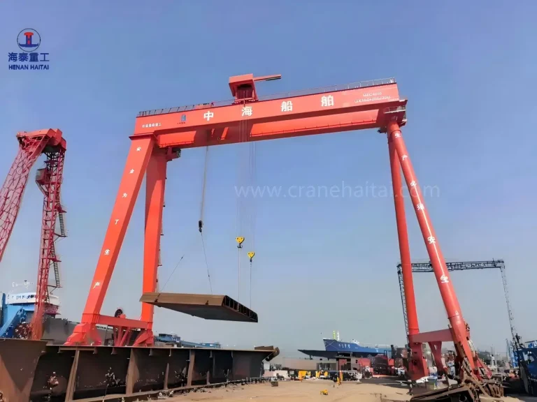 Haitai rubber‑tyred shipbuilding gantry crane lifting heavy hull block for ship assembly at Zhonghai Shipbuilding