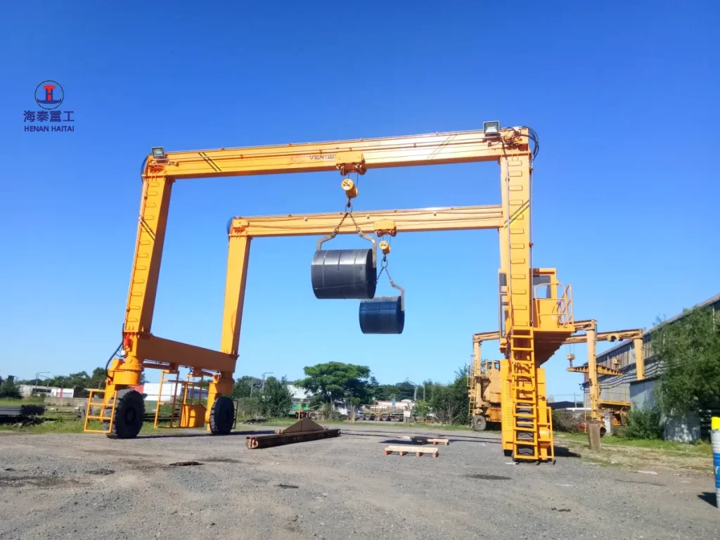 Haitai 12.5+12.5 ton dual-hoist RTG crane lifting steel coils at a customer yard in argentina