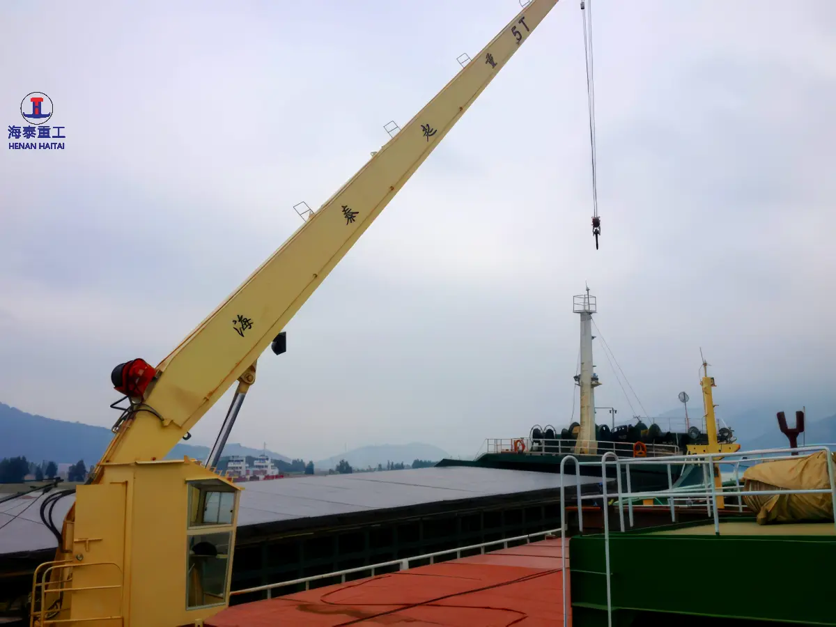 Haitai hydraulic stiff boom crane with hook block lowered and rated capacity marked on the boom