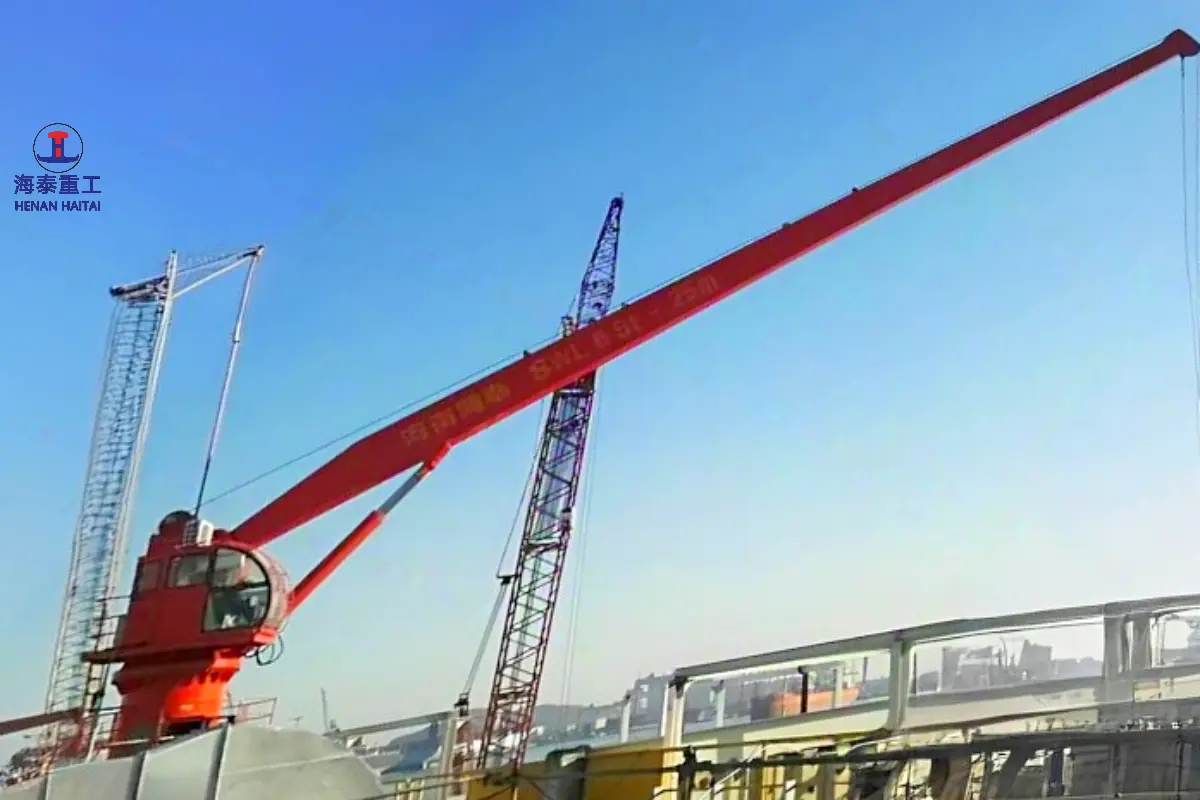 Hydraulic stiff boom crane boom structure viewed against open sky, mounted on a marine vessel