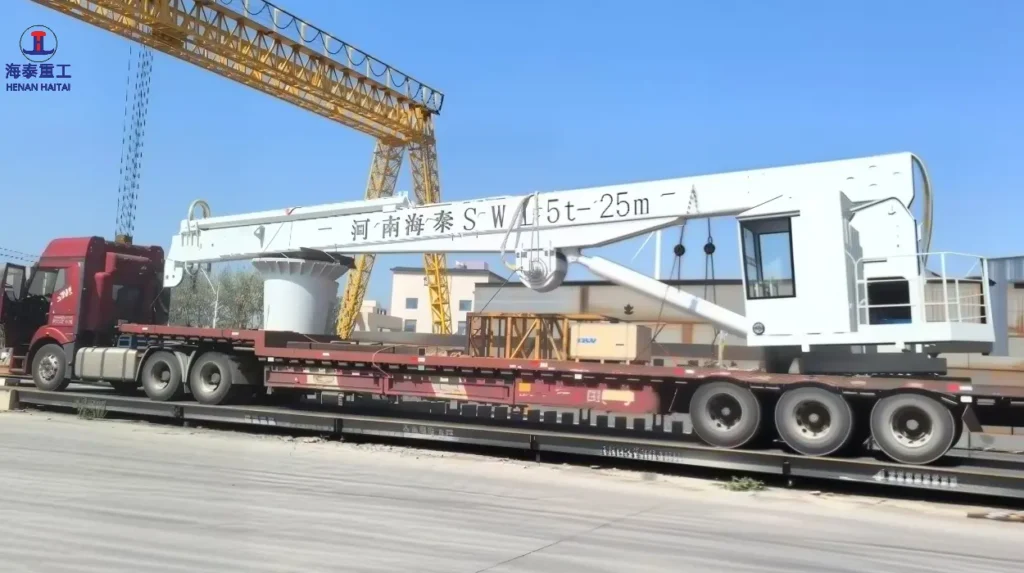 Henan Haitai 5t-25m hydraulic telescopic boom marine crane loaded for export to Romania, 2026
