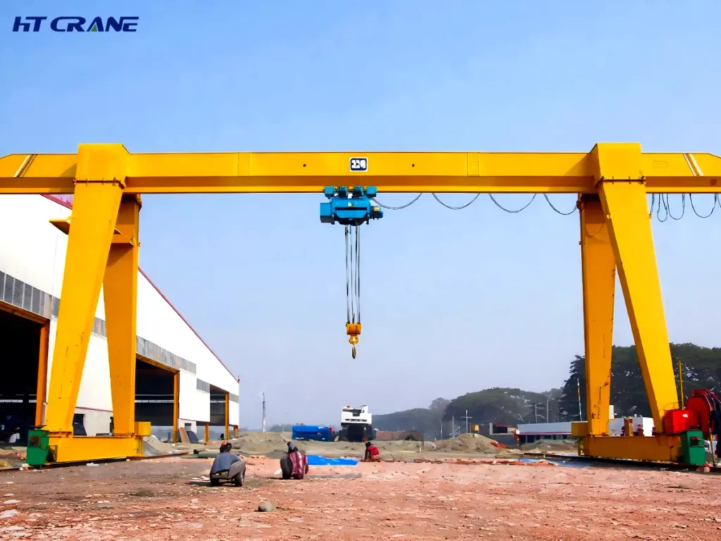 Electric hoist and trolley suspended beneath a single girder gantry crane, with hook lowered