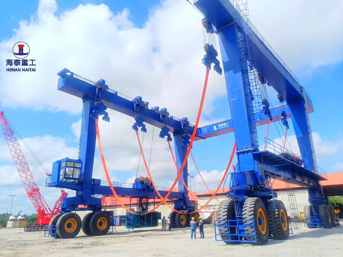Close-up of the Haitai MBH-500t-21m marine travel lift showing the lifting slings, hoisting components, steel frame, and operator cabin.