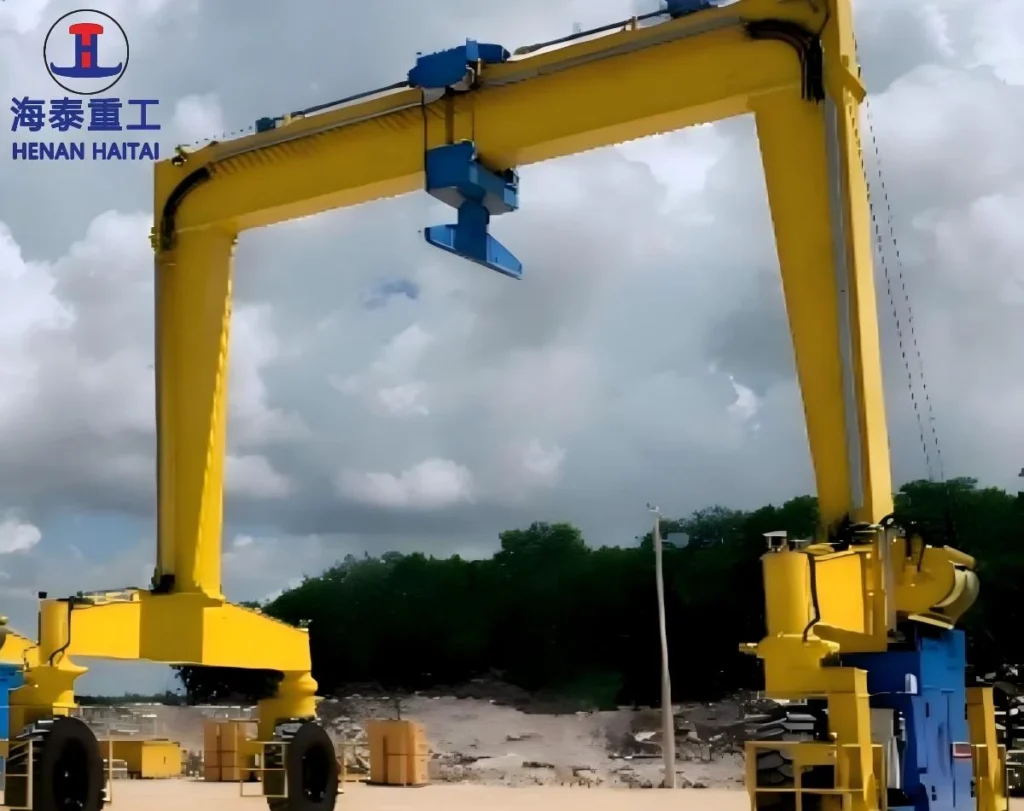 Haitai single girder rubber tyred gantry crane with a yellow main girder and trolley, travelling on rubber tyres in an outdoor yard